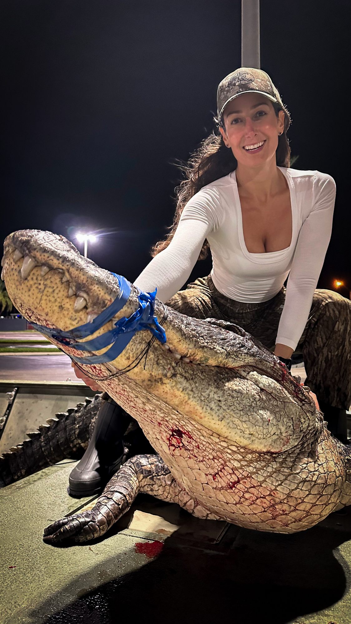 Lauren Sarasua with the alligator from a hunt on Lake Okeechobee, Florida