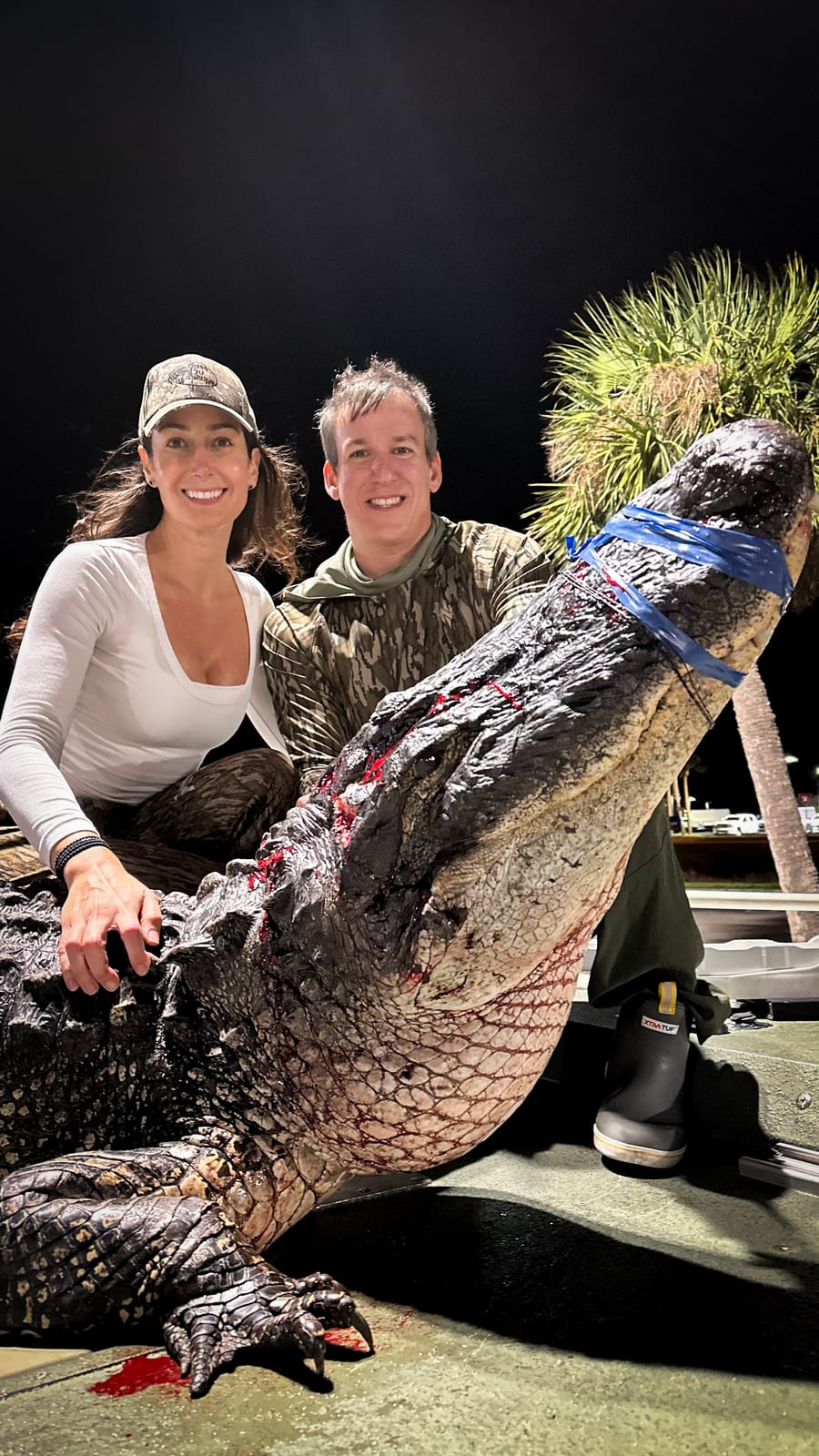 Lauren Sarasua and Jose with an 11 foot alligator they hunted on Lake Okeechobee, Florida
