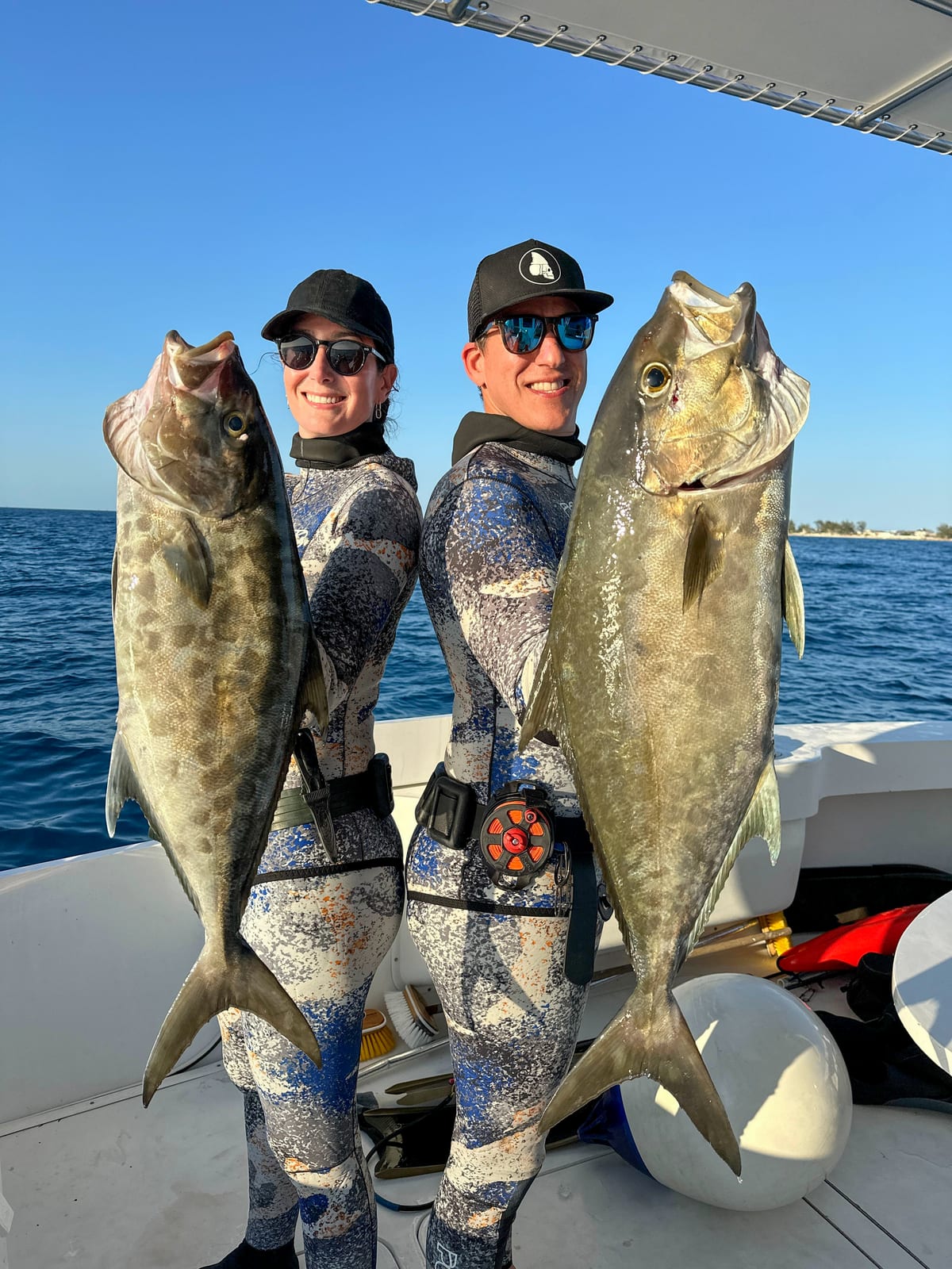 Lauren Sarasua and Jose in the Bahamas with the almaco jacks they shot