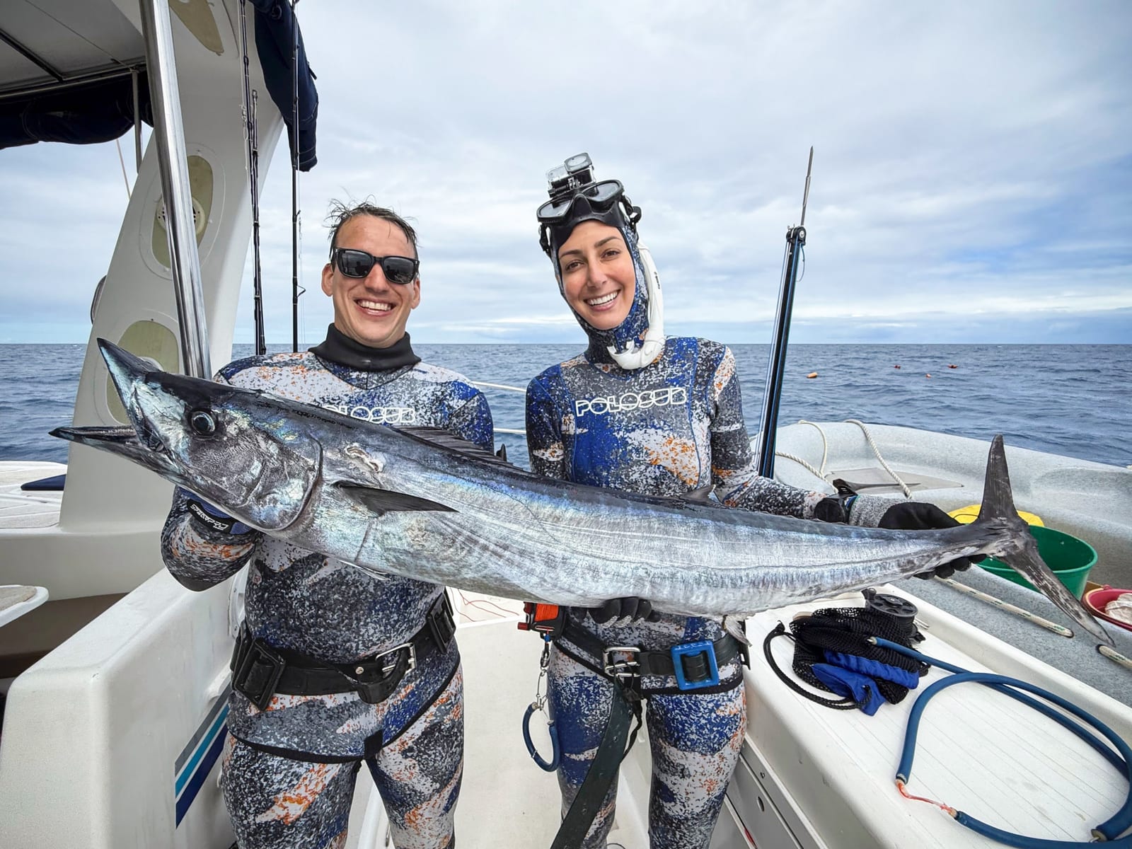 Lauren Sarasua and Jose holding the wahoo Lauren shot in Madagascar